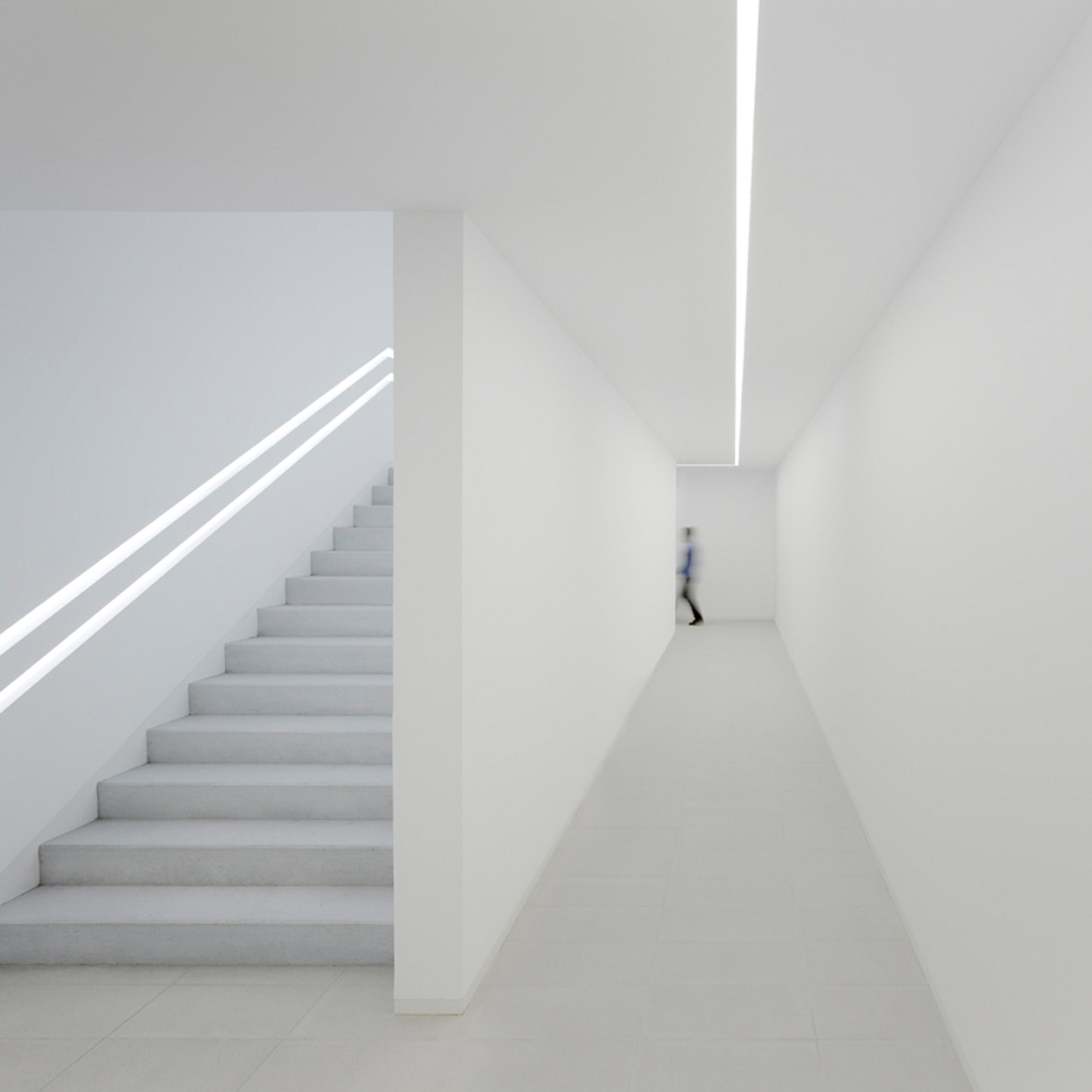 Linear lighting acts as a guidance system in a hallway.