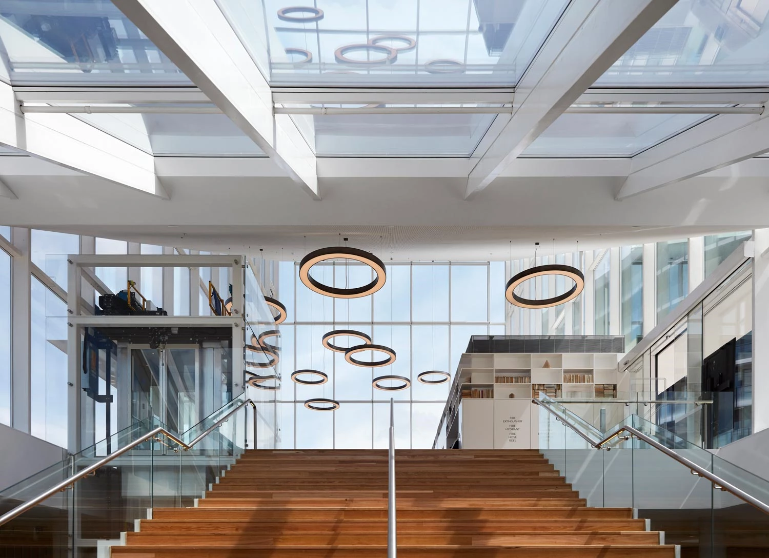 Round pendant luminaire for open communal areas with stairs