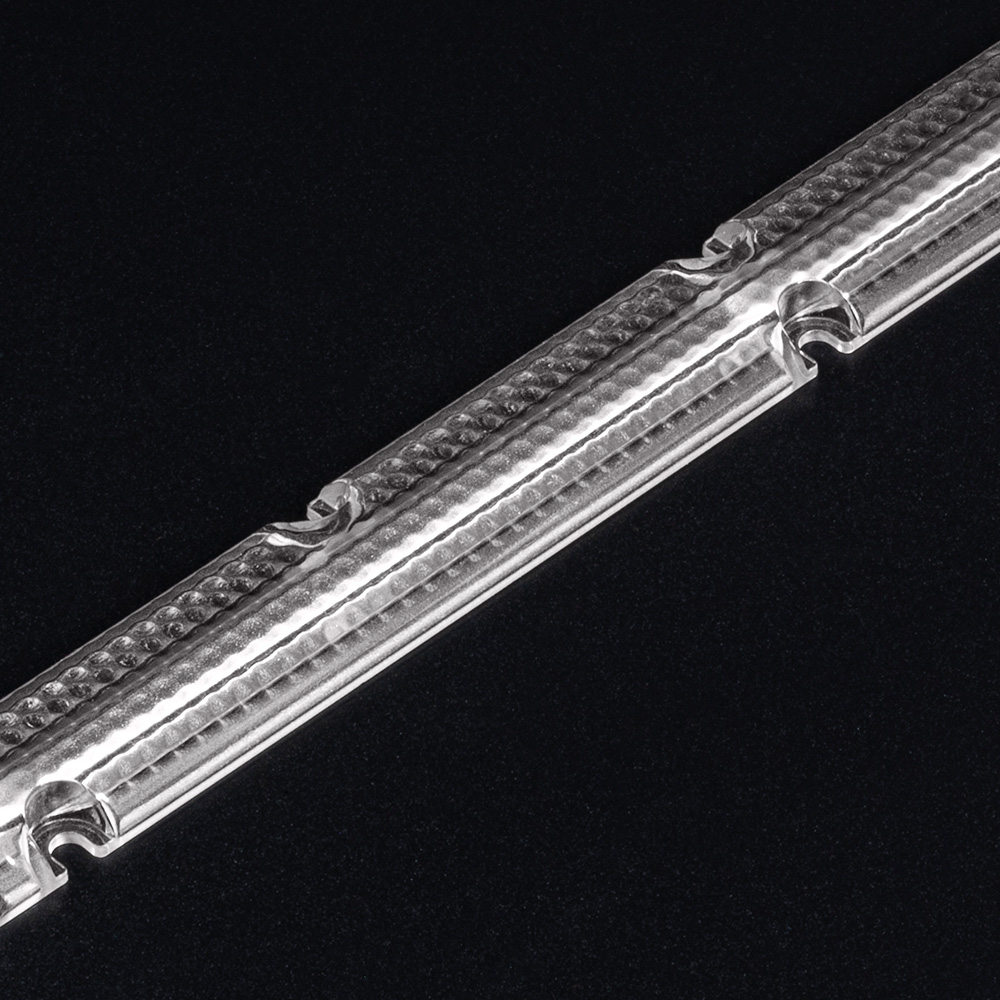 Stage 5 of Batwing lens development – light distribution optimised for low room heights with homogeneous illumination. (Photo of lens)