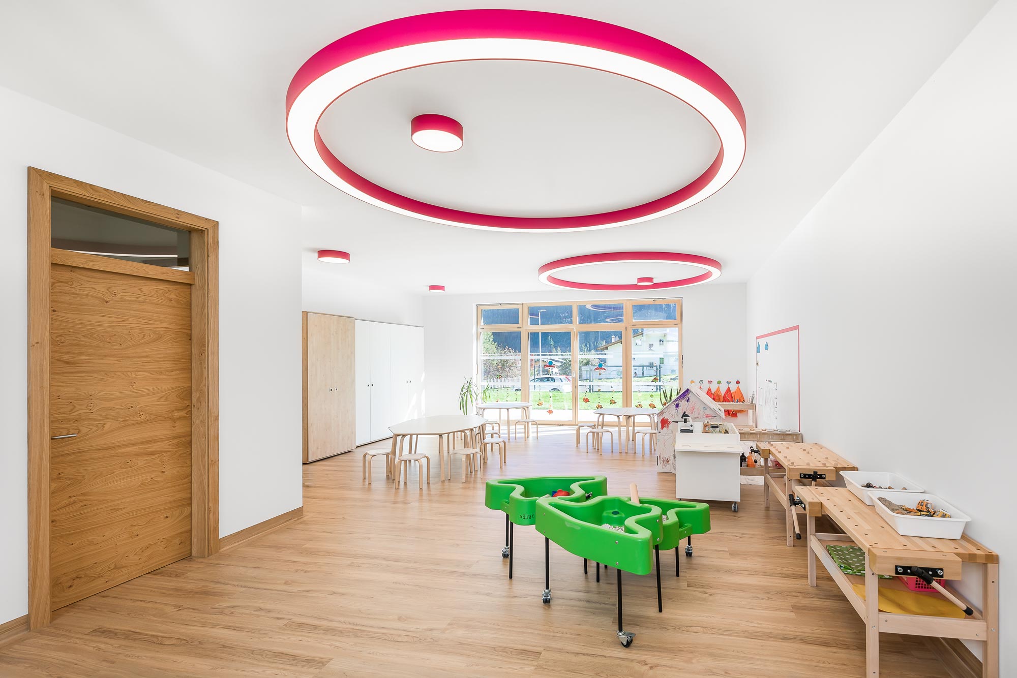 Pink round surface-mounted luminaire for uniform ceiling lighting in the kindergarten