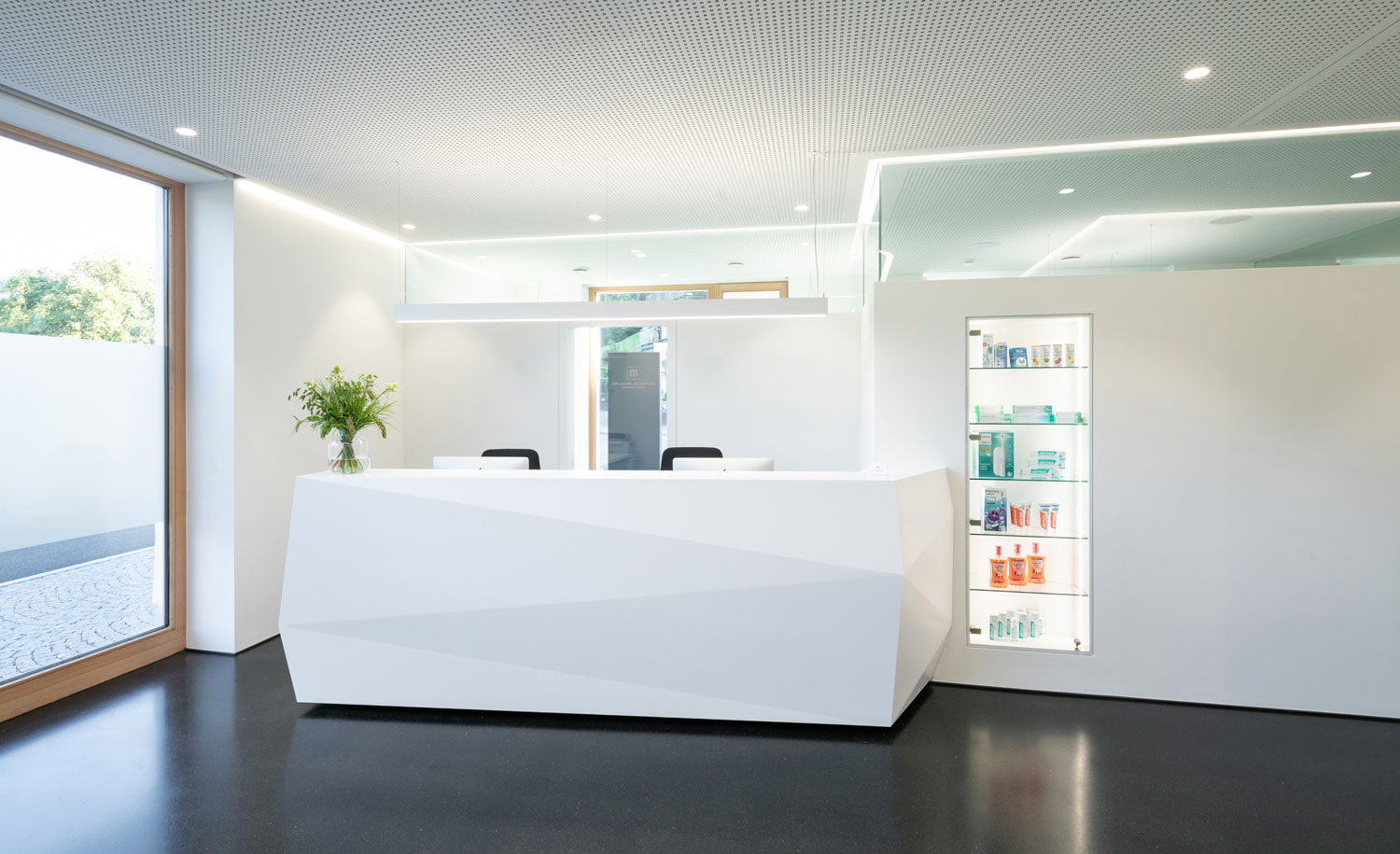 Bright and modern ceiling lighting in the reception area of a doctor's office creates a friendly atmosphere for patients and visitors.